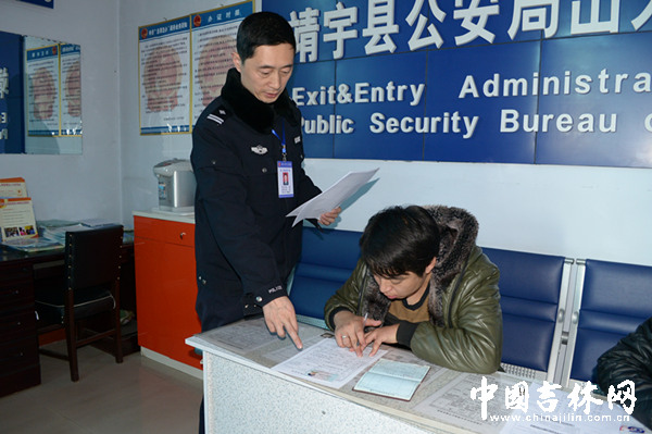（工作照片）张林在指导办事群众填写出入境相关审批表.jpg